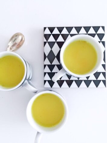 A trio of cups with golden milk.