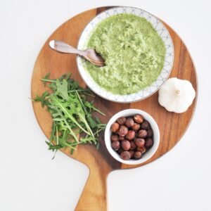 Arugula pesto on a wood board.