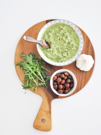 Arugula pesto on a wood board.