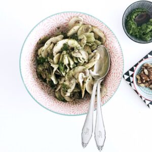 Salad bowl with raw mushrooms and a delicious parsley pesto.