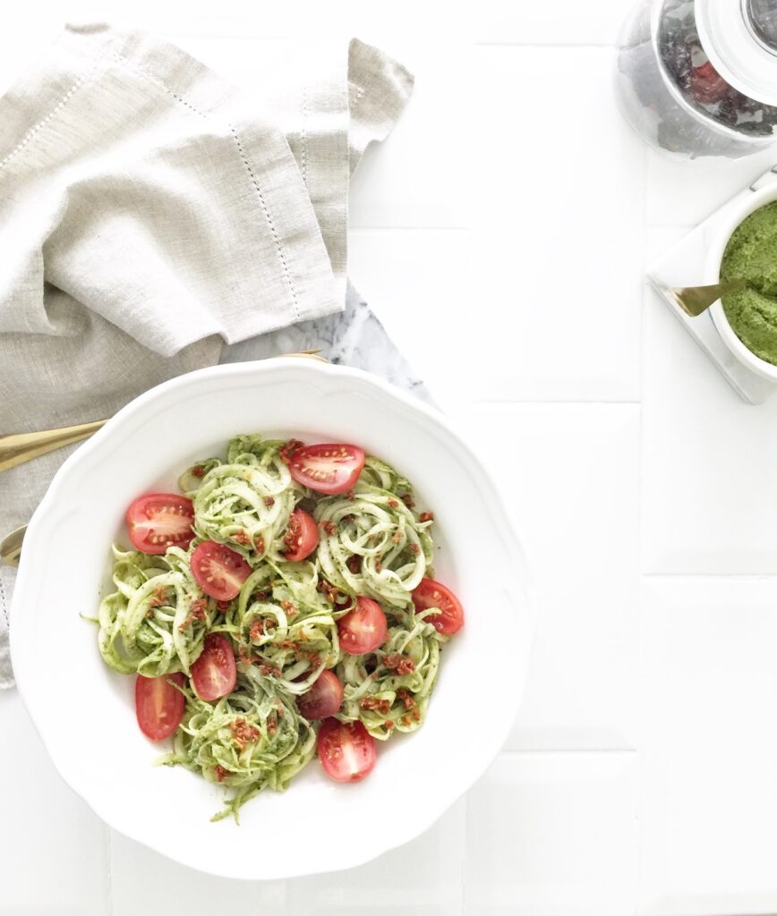 Pesto zucchini noodles with fresh and dried tomatoes